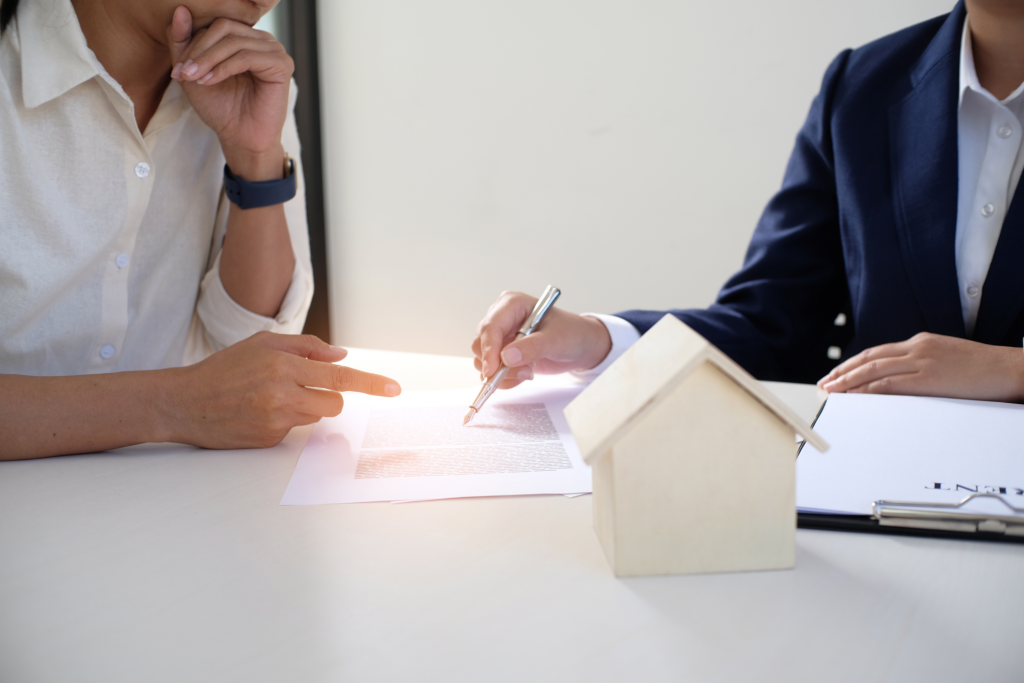 Signing paperwork for a rental property — landlord insurance in Little Elm, TX