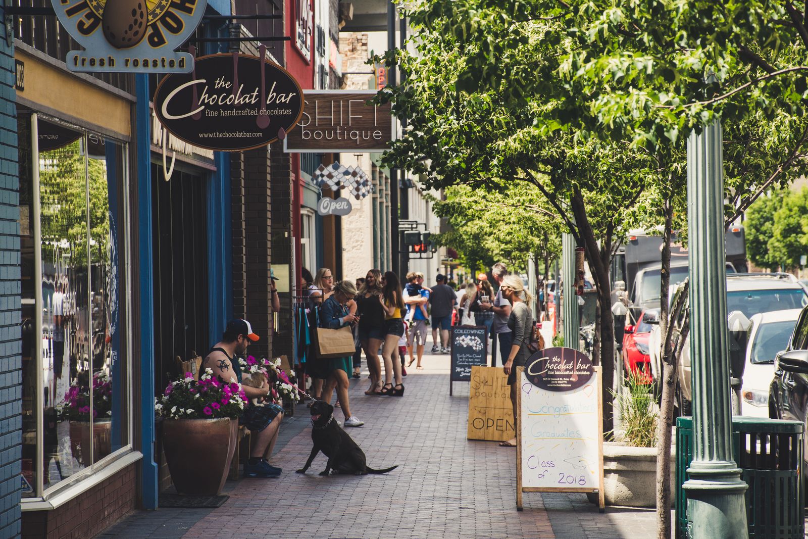 Shoppers on a vibrant downtown street with storefronts — retail insurance in the DFW area